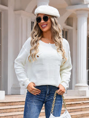 White textured knit sweater with a chest pocket and button details.