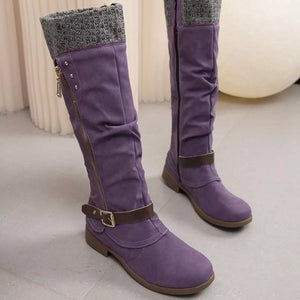 Purple suede slouch knee-high boots with knit cuff and buckle strap detail.