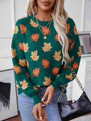 Green knit sweater with allover orange and yellow leaf pattern, crew neck, long sleeves.