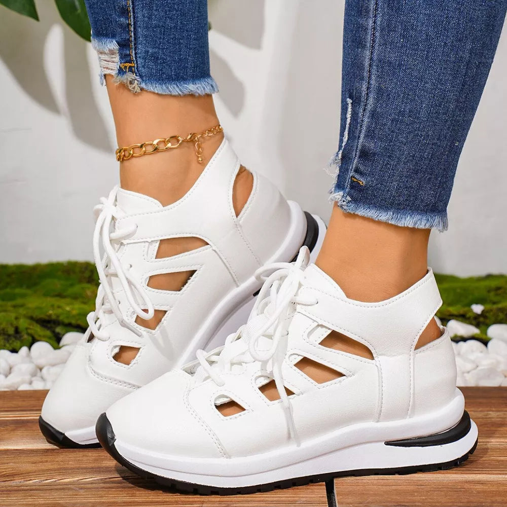 White lace-up sneakers with cut-out details and round toe.
