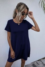 Dark blue relaxed pocketed tee dress with short sleeves and a crew neck.