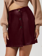 Burgundy faux leather asymmetric button-front mini skirt