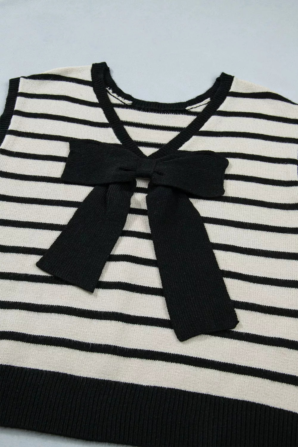 Chic striped knit cardigan with black bow detail and V-neck