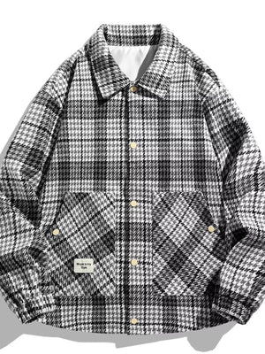 Men's black and white houndstooth button-up sport jacket with two chest pockets.