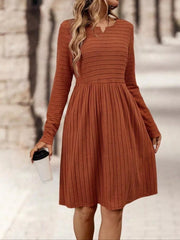 Rust ribbed knit A-line dress with long sleeves and a V-neckline.