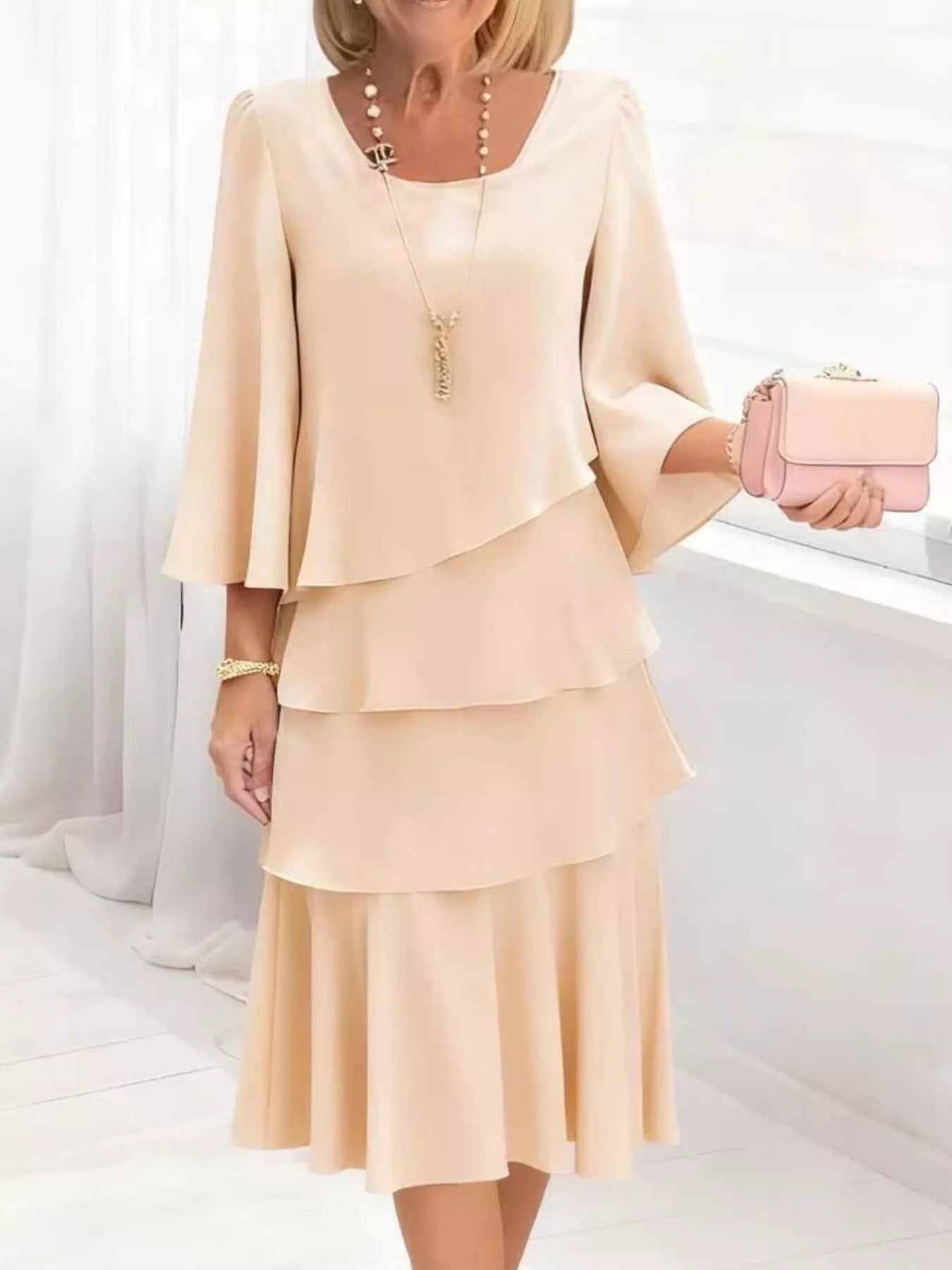 Elegant tiered dress in tan with 3/4 bell sleeves and a square neckline.