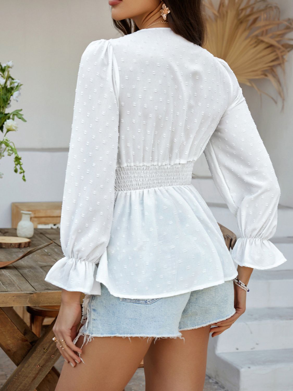 White Swiss dot blouse with smocked waist and ruffled cuffs