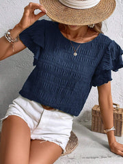 Dark blue textured smocked blouse with ruffle sleeves.