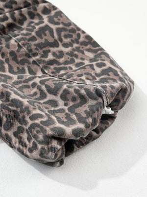 Denim blouse with leopard print and V-neck detail.