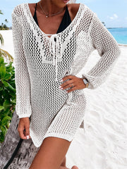 White open-knit beach dress with lace-up neckline and long sleeves.