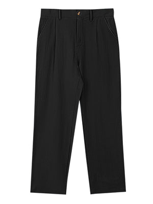 Black relaxed fit sweatpants with pleats and button closure.