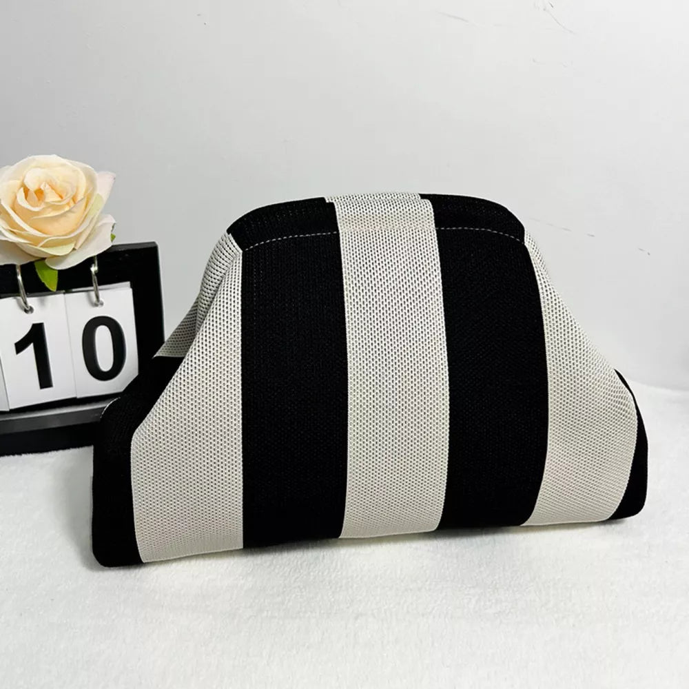 Vibrant knit clutch with striking black and white stripes.
