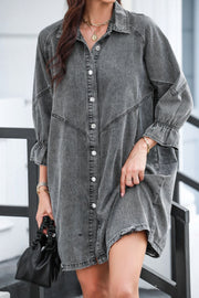 Gray denim shirtdress with button front and ruffled cuff detail.