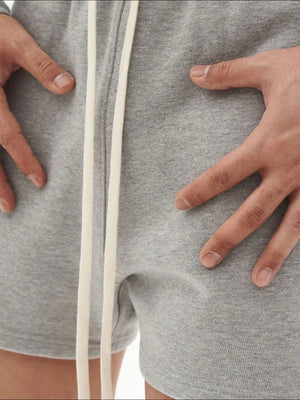 Relaxed fit gray cotton jersey jogger shorts with white drawstring detail.