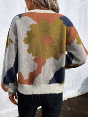 Abstract floral knit sweater with round neck in multicolor, featuring a large yellow flower detail.