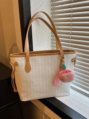 Textured diamond woven tote bag in white with tan trim and a peach charm.