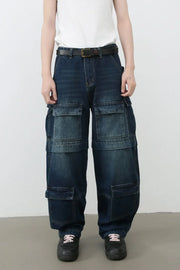 Dark denim cargo pants with layered pockets and a relaxed fit.