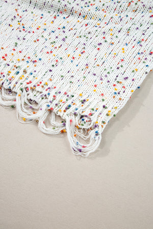 White confetti knit sweater with colorful flecks and distressed fringe hem.