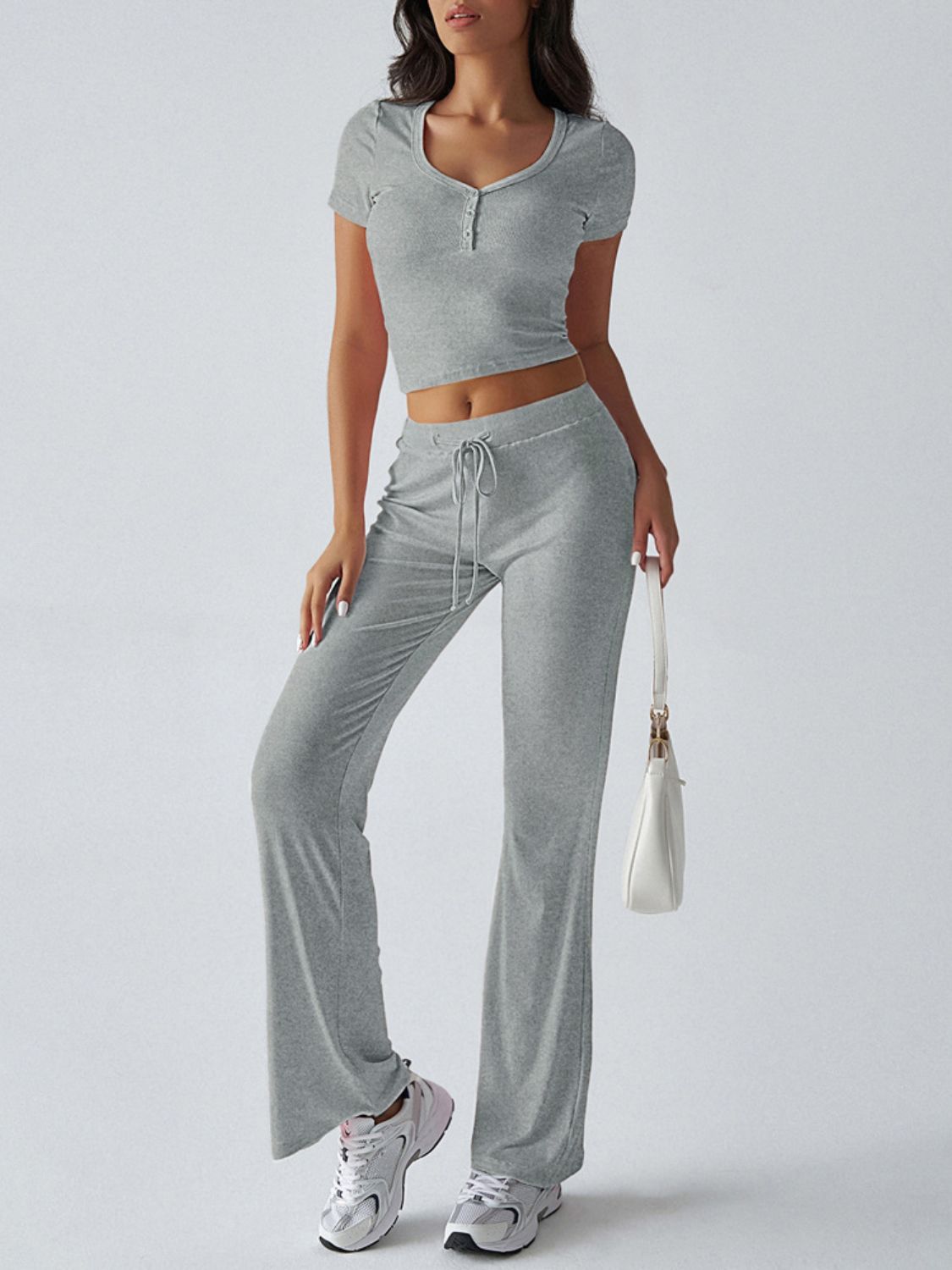 Light gray button-front crop top and flared lounge pants with drawstring waist.