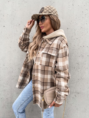Oversized plaid shacket with attached hood in camel and white, featuring buttoned front and chest pockets.