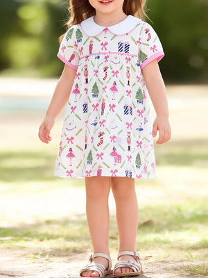 Toddler a-line dress with Peter Pan collar, short sleeves, and a whimsical nutcracker print.