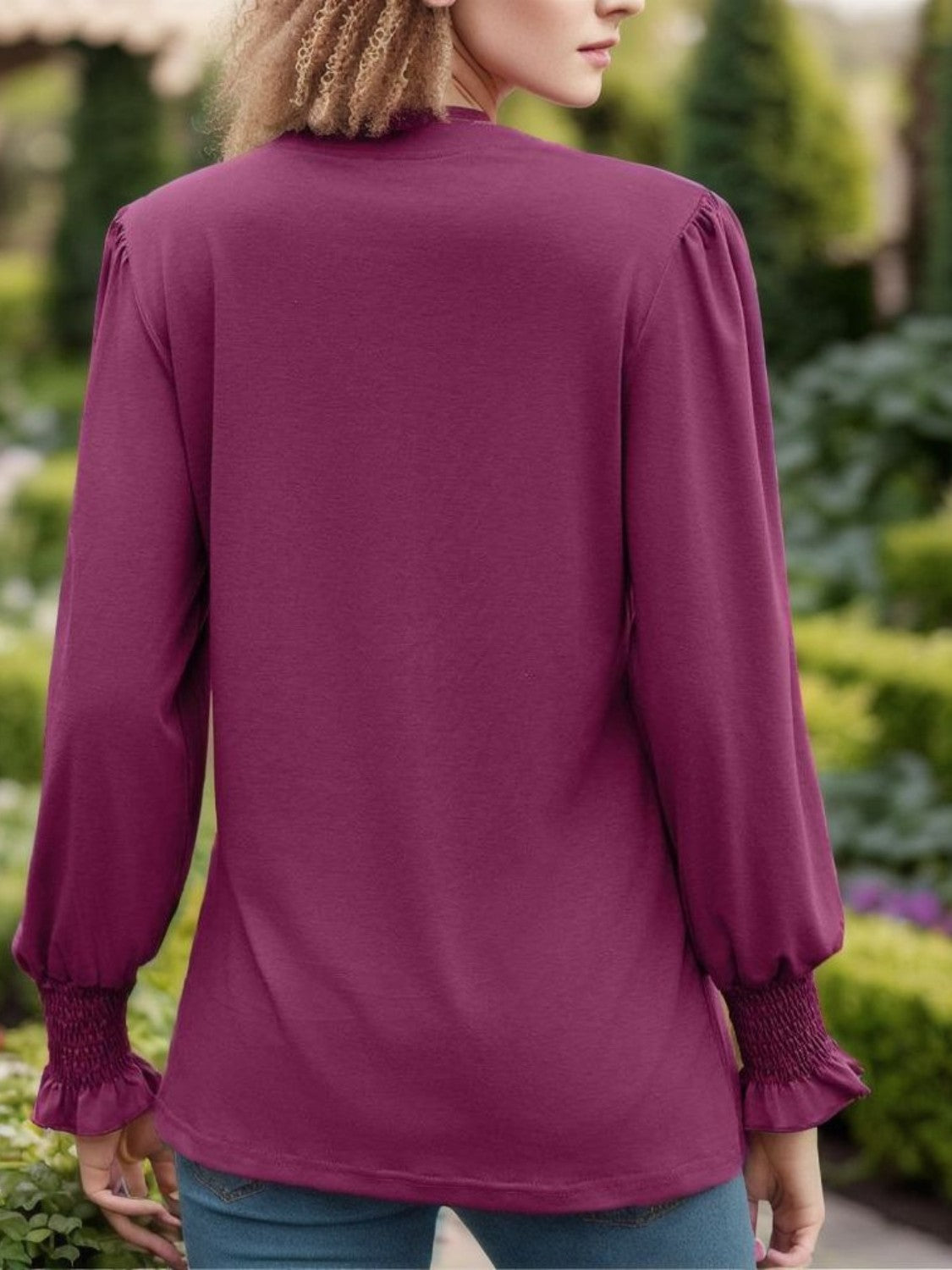 Deep purple blouse with gathered cuffs and pleated yoke detail.