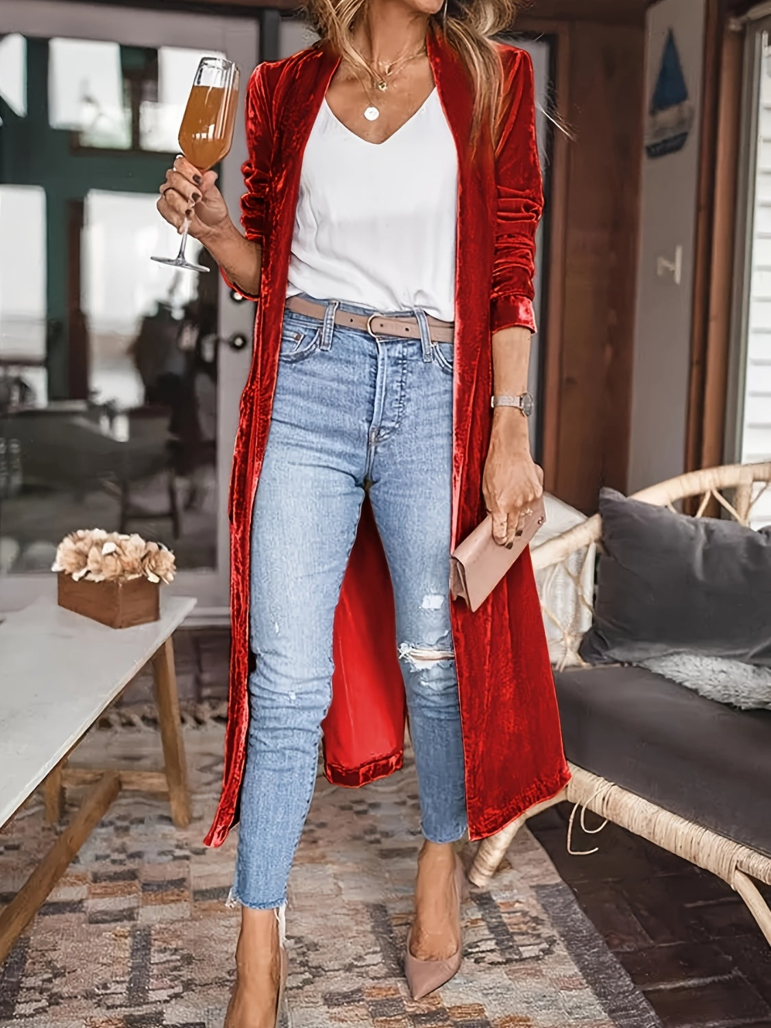 Burgundy velvet duster coat with fluid silhouette, open front, long sleeves, worn with jeans.