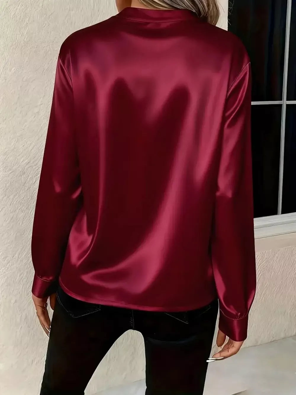 Wine red satin maternity blouse with long sleeves and buttoned cuffs.