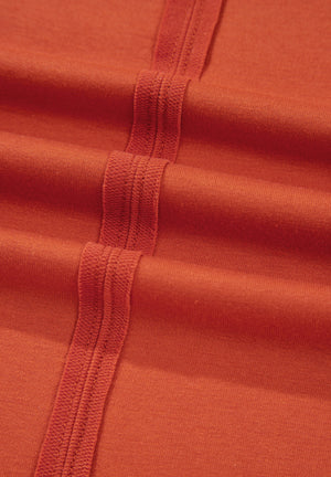 Orange-red blouse with balloon sleeves and patchwork detail.