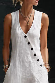 White asymmetrical button-down midi dress with V-neck and black buttons.