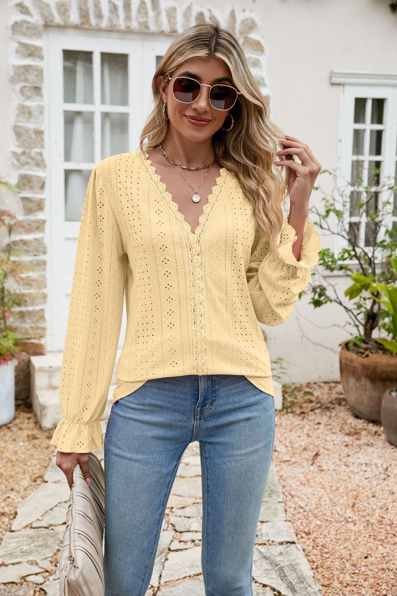 Light yellow eyelet lace blouse with ruffle sleeves and V-neckline