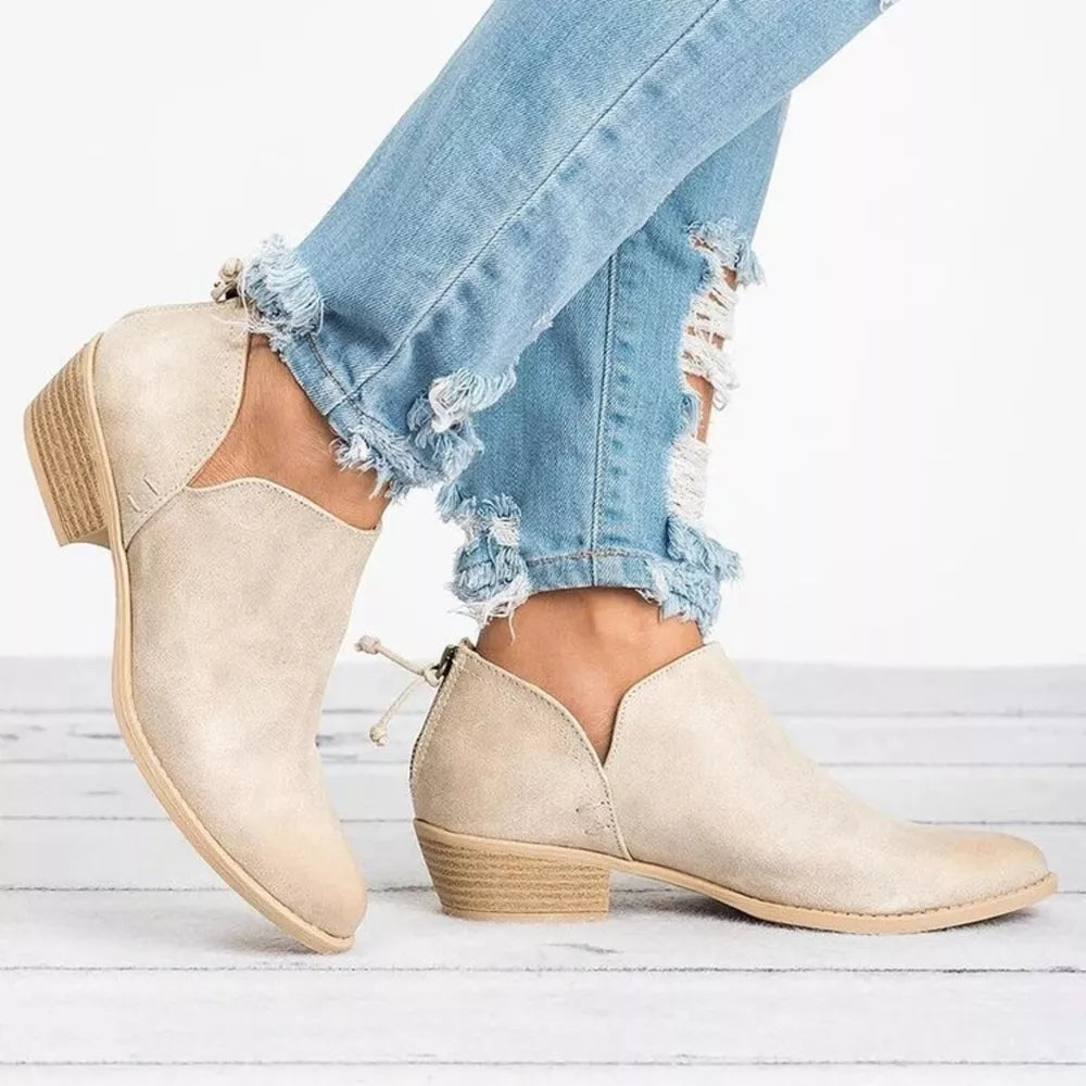 Beige V-cut pointed toe block heel boots with a back zipper detail.