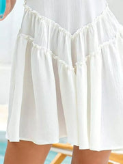 White frill tiered mini dress with ruffled details and a pocket.