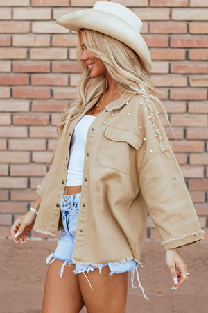 Tan utility jacket with pearl embellishments and raw edges, featuring button front and chest pockets.