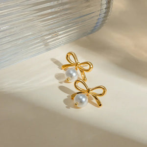 Gold bow drop earrings with pearl accents