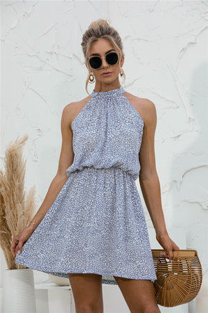 Misty blue floral halter neck mini dress with elastic waist and flowy skirt.