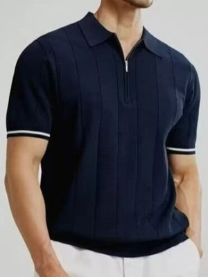 Navy blue cotton quarter-zip polo shirt with vertical ribbing and white sleeve cuffs.
