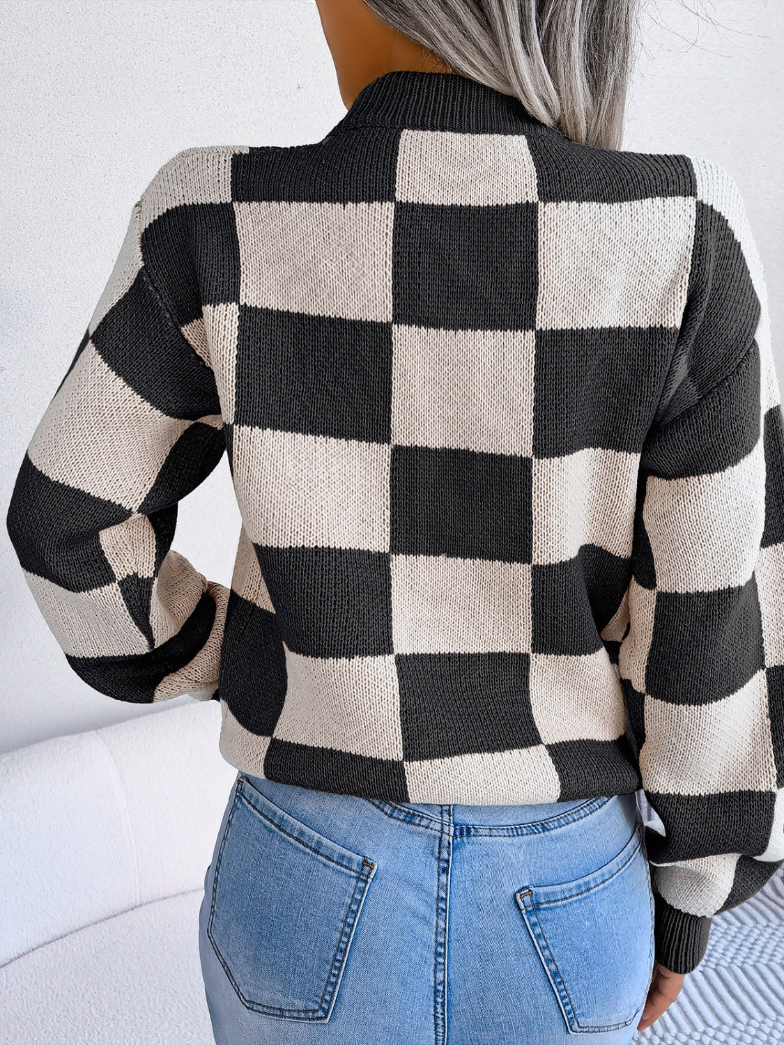Checkerboard knit mock neck pullover sweater in black and white acrylic.