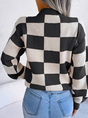 Checkerboard knit mock neck pullover sweater in black and white acrylic.