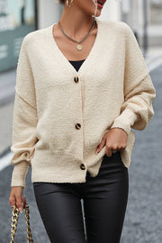 Cream textured bouclé button-down cardigan with V-neck and balloon sleeves.