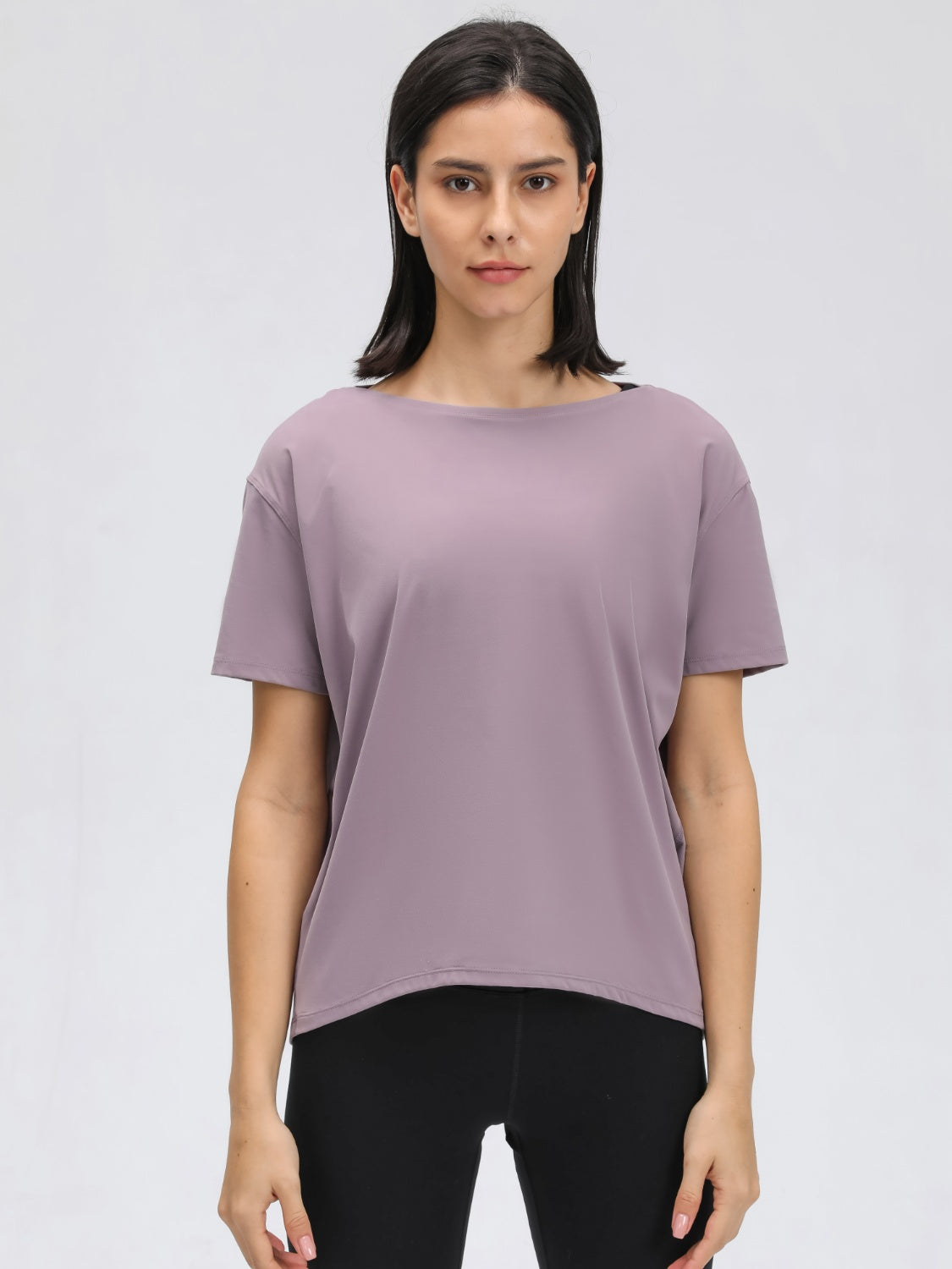 Lilac relaxed fit performance tee with short sleeves and a boat neckline.