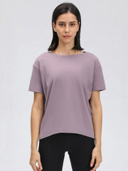 Lilac relaxed fit performance tee with short sleeves and a boat neckline.