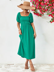 Green midi dress with gathered bodice, square neckline, puff sleeves, and A-line skirt.