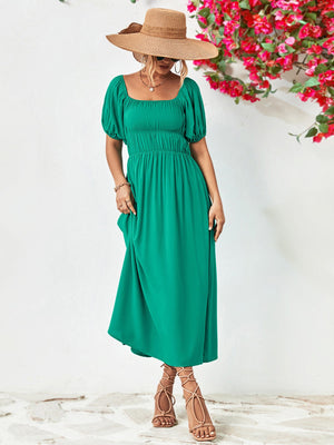 Green midi dress with gathered bodice, square neckline, puff sleeves, and A-line skirt.