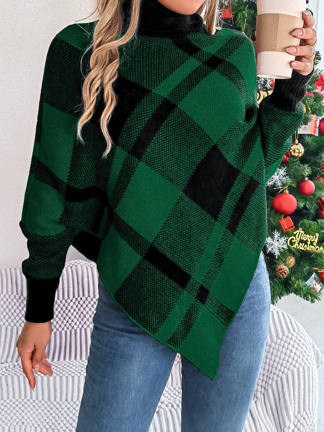 Green and black tartan turtleneck poncho sweater with asymmetric hem.