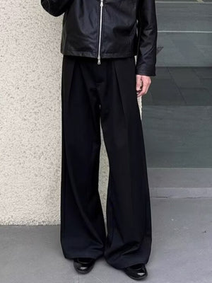 Men's black wide-leg sweatpants with pleats and a relaxed fit.
