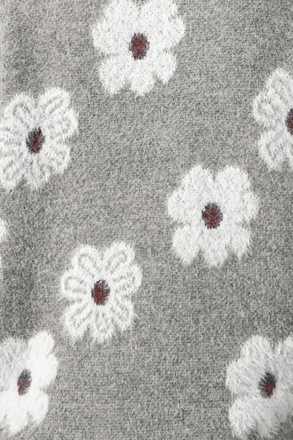 Gray acrylic sweater with white floral intarsia pattern and mock neck detail.