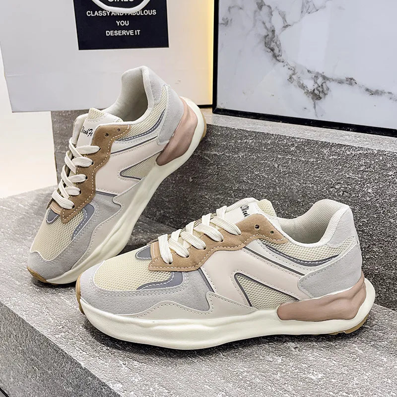 Panelled retro runner sneakers in beige and grey with tan accents and a chunky sole.