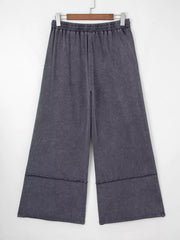 Maternity cropped wide-leg trousers in charcoal cotton with elastic waist and raw hem detail.