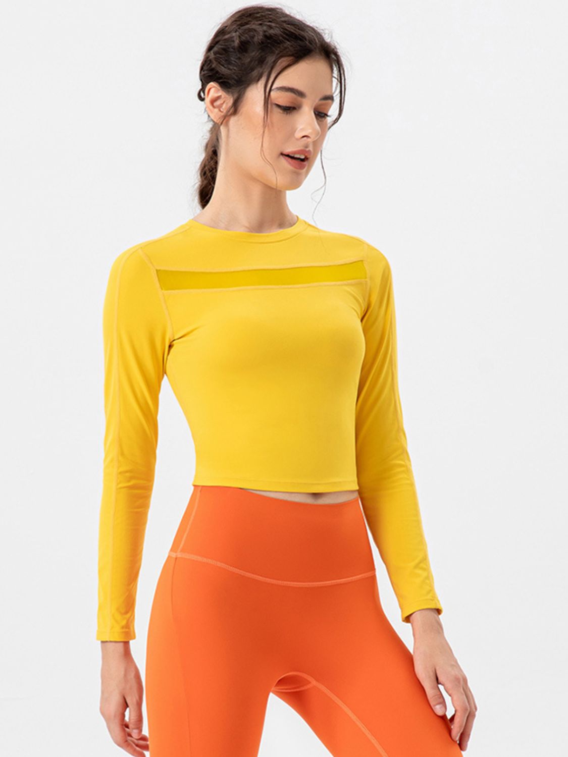 Neon yellow long sleeve crop top with mesh chest detail.